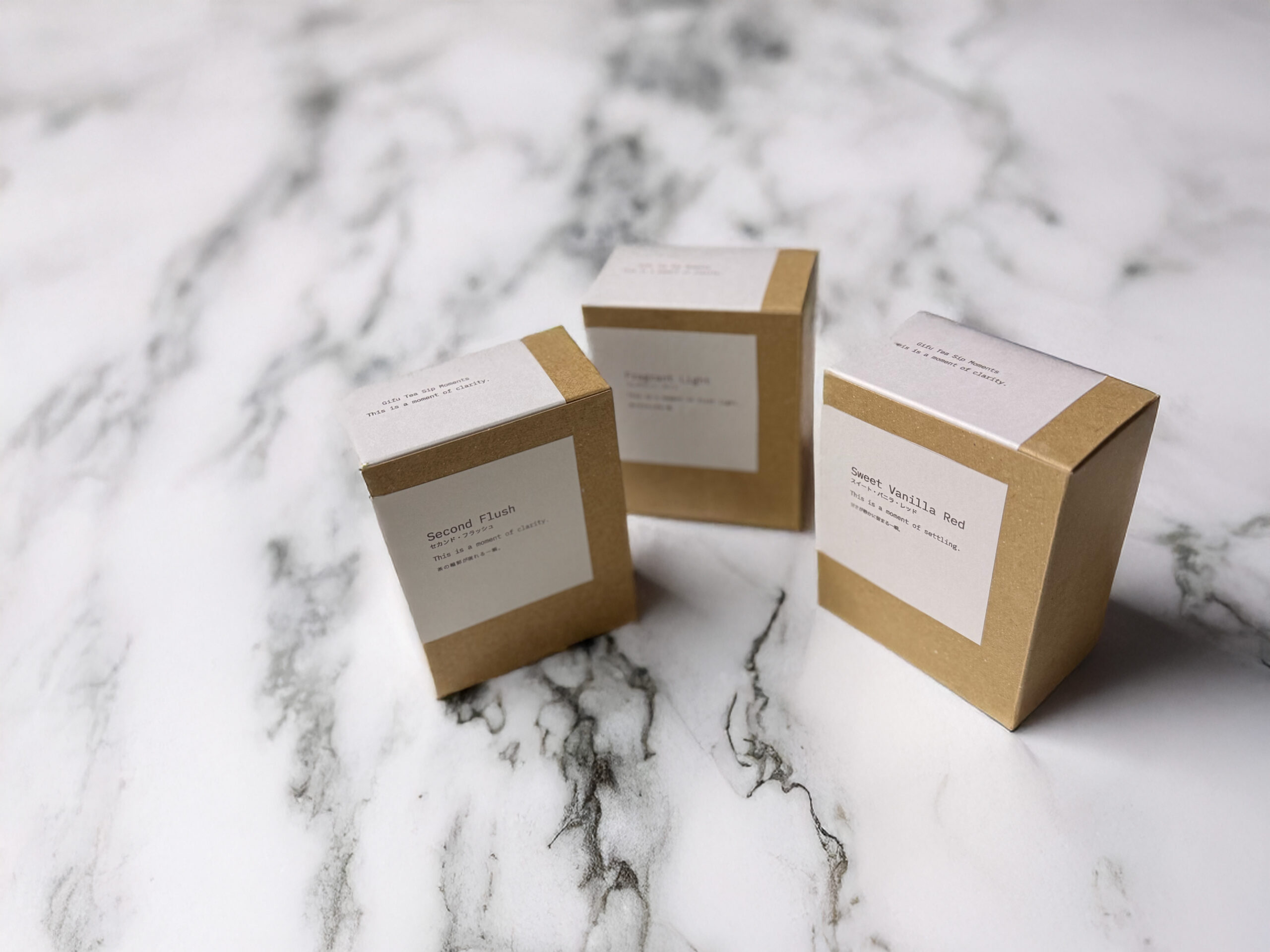 Vanilla Collection packaging – three Japanese black tea boxes on a marble surface.